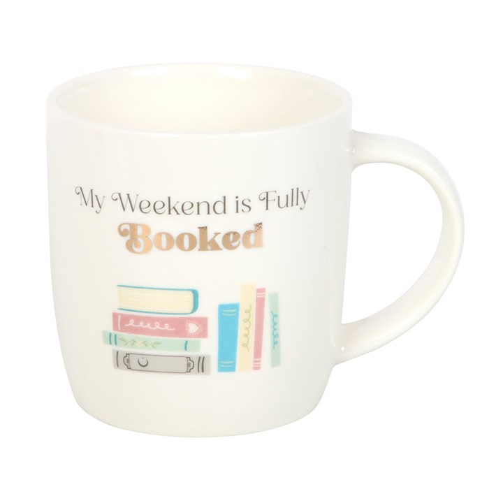 White ceramic mug with the phrase 'My Weekend is Fully Booked' and a pastel illustration of books on a white background