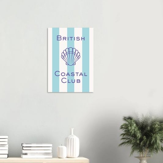 Aesthetic coastal art print titled British Coastal Club featuring a purple geometric scallop shell illustration and matching thin border over a light blue and white vertically striped background.
