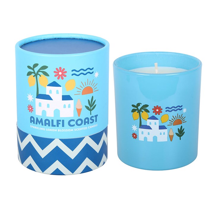 Sky blue frosted glass candle featuring white villa and lemon illustrations, sitting next to a matching blue and white chevron gift tube on a white background