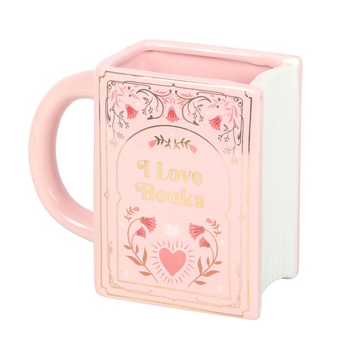 Pastel pink rectangular ceramic mug shaped like a hardcover book with gold floral illustrations and the words 'I Love Books' printed on the cover on a white background