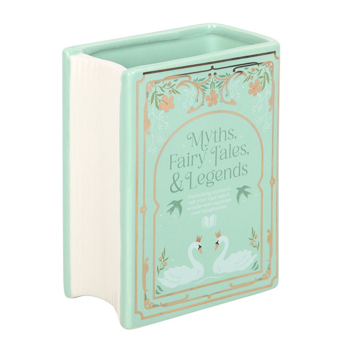 Sage green ceramic vase shaped like an upright fairytale book reading 'Myths, Fairy Tales, & Legends', showing white page end of vase on a white background.