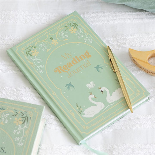 Sage green A5 hardcover notebook with gold foil lettering reading 'My Reading Journal' with white swan illustrations, lying flat next to a gold pen.