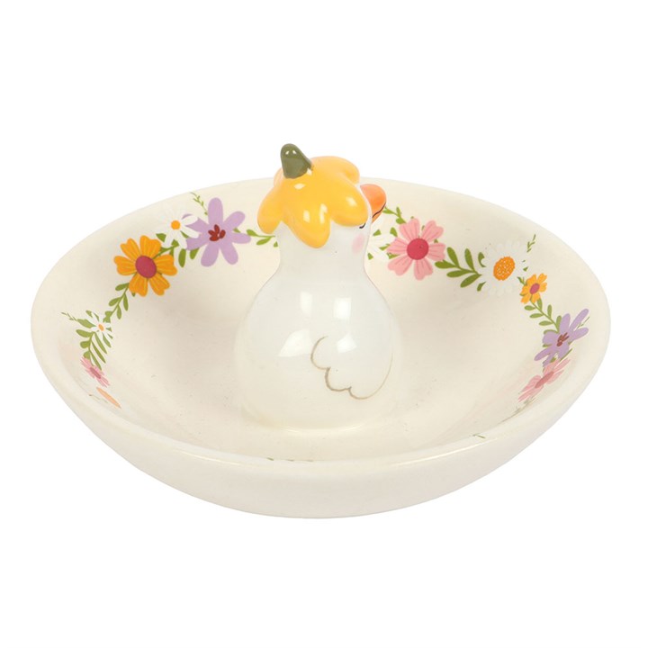 Rear view of A small white ceramic trinket dish with a pastel wildflower border and a 3D duck figure in a yellow flower hat in the center, on a white background
