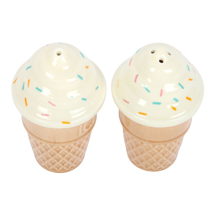 Top of wo ceramic salt and pepper shakers shaped like ice cream cones with white soft-serve swirls and colourful sprinkles on white background