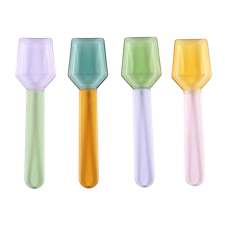 Four translucent glass dessert spoons in pastel lilac, blue, green, yellow on a white background