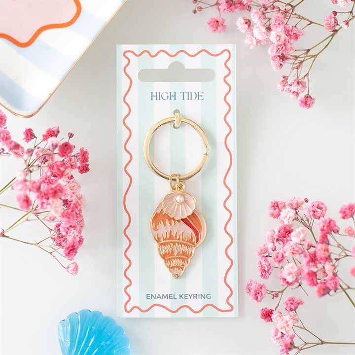Peach and coral enamel conch shell keyring with a small oyster pearl detail on a blue and white striped gift card.