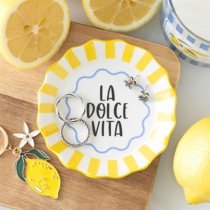 Round scalloped ceramic trinket dish with yellow and white stripes and 'La Dolce Vita' text in the center.