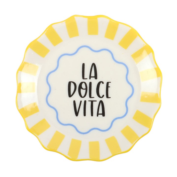 Round scalloped ceramic trinket dish with yellow and white stripes and 'La Dolce Vita' text in the center on white background