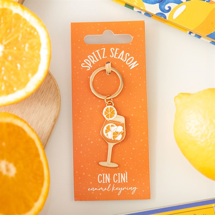 Gold-tone enamel keyring featuring a vibrant orange spritz cocktail glass with an orange slice 
