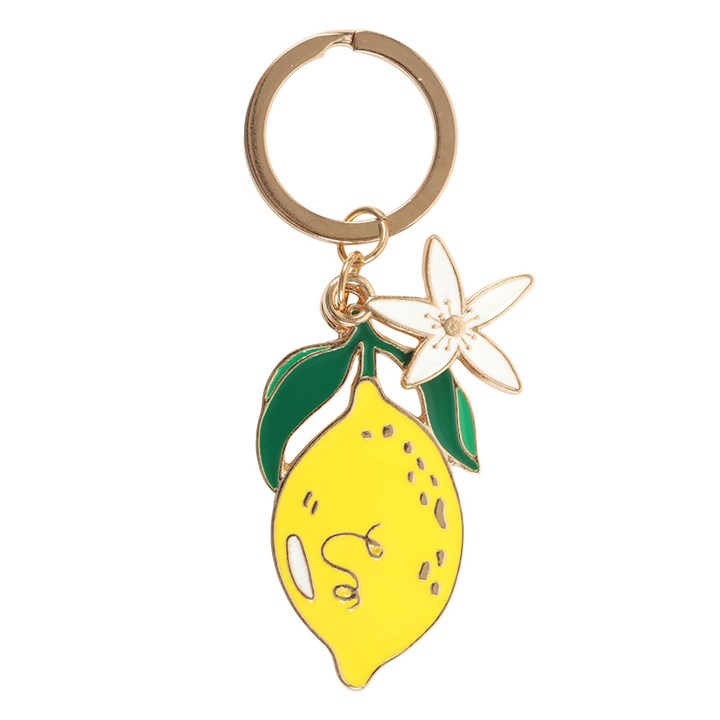 Gold-tone enamel keyring featuring a bright yellow lemon charm and a small white five-petal flower charm on white background