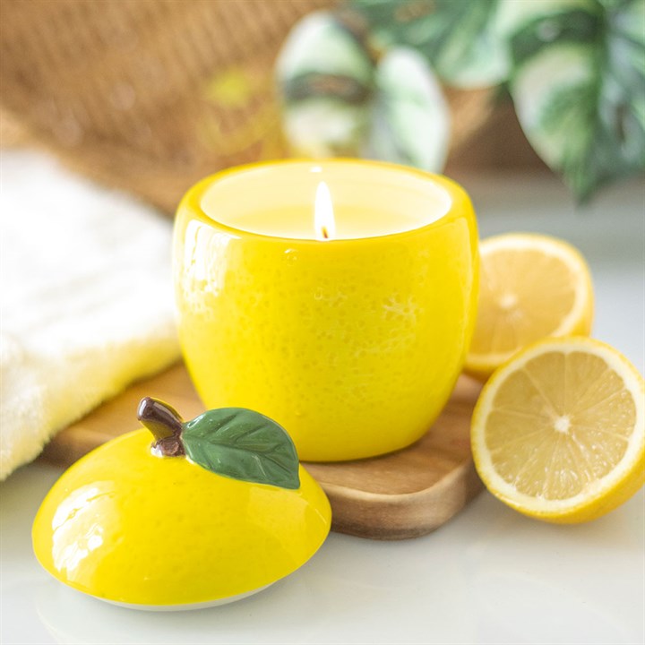 Textured yellow ceramic candle jar shaped like a lemon with green leaf detail